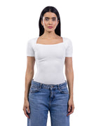 A woman modeling a fitted white short-sleeve top with a square neckline, paired with blue jeans, against a plain white background. [model:2]