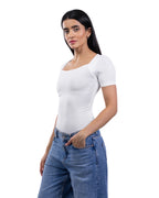 A woman modeling a fitted white short-sleeve scoop-neck top paired with blue jeans against a plain white background. [model:2]