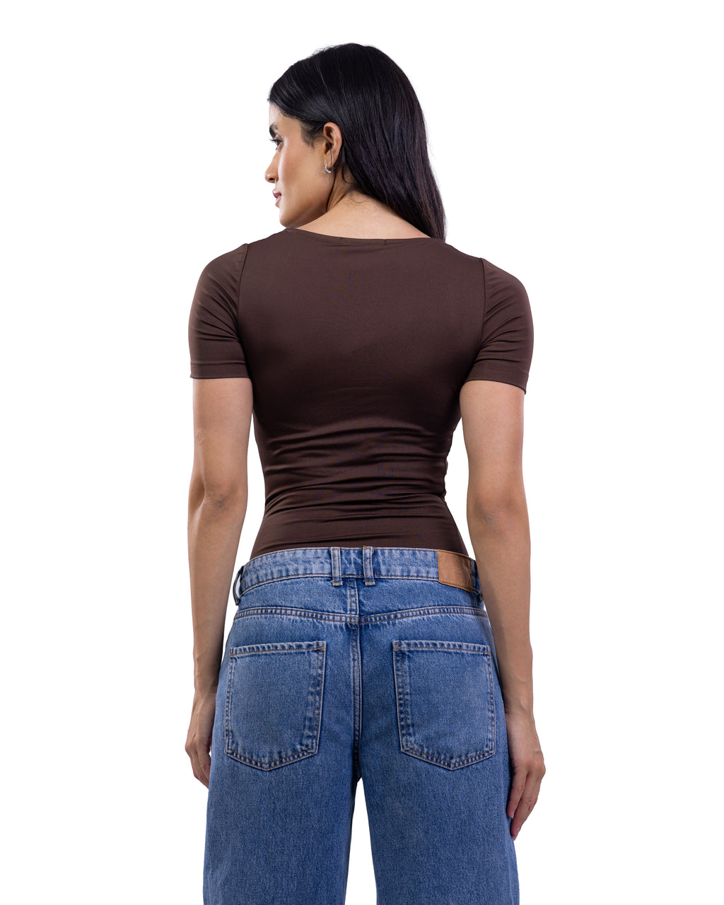 A woman shown from the back wearing a fitted short-sleeve brown top and blue jeans against a plain white background.
