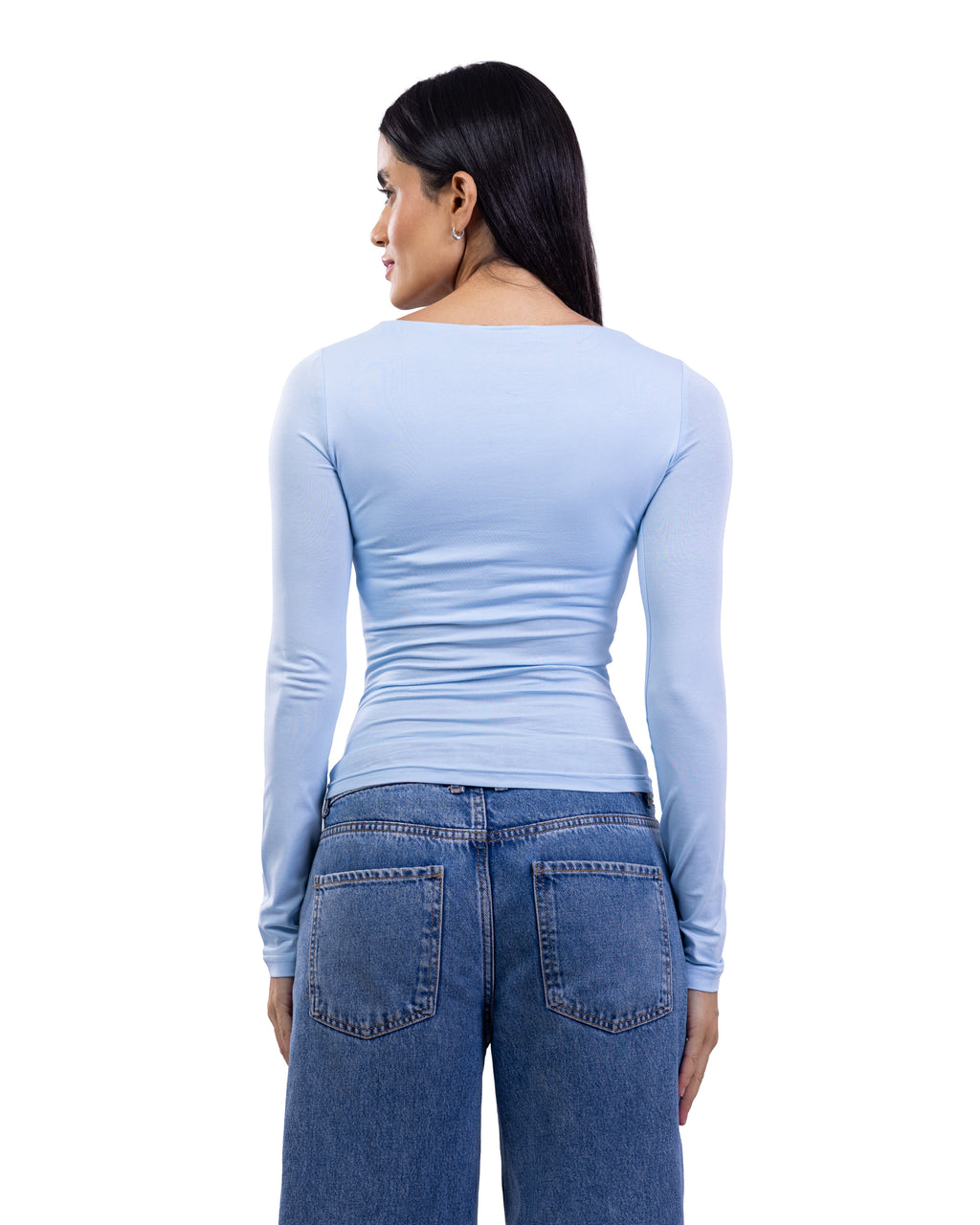 A woman shown from the back wearing a light blue long-sleeve top and blue jeans against a plain white background.