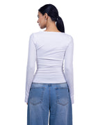 A woman shown from the back wearing a fitted white long-sleeve top and blue jeans against a plain white background.