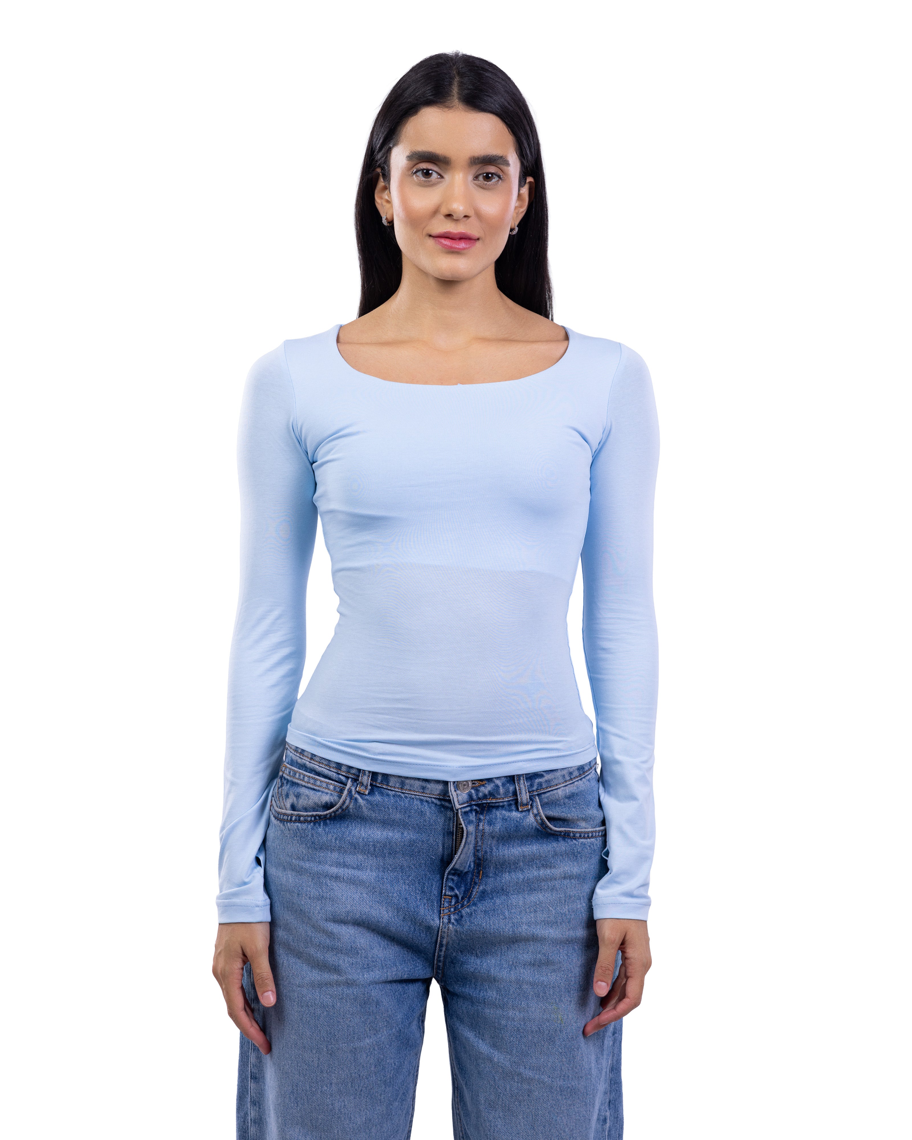A woman modeling a light blue long-sleeve scoop-neck top paired with blue jeans, shot against a solid white background.