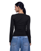 A woman shown from the back wearing a fitted black long-sleeve top and light blue jeans against a plain white background. [model:1]