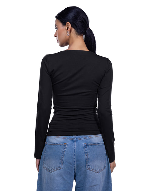 A woman shown from the back wearing a fitted black long-sleeve top and light blue jeans against a plain white background.