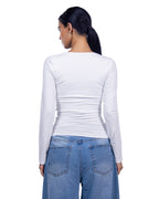 A woman shown from the back wearing a fitted white long-sleeve top and blue jeans against a plain white background. [model:1]