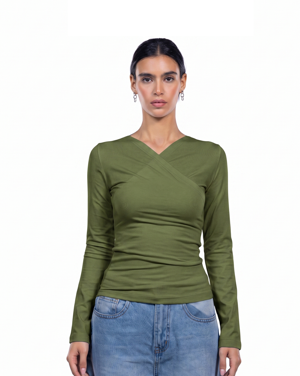 A woman modeling a fitted olive green long-sleeve top with a V-neck and crossover detail at the chest, paired with light blue jeans against a plain white background. [model:1]