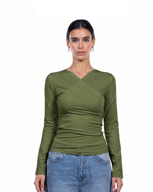A woman modeling a fitted olive green long-sleeve top with a V-neck and crossover detail at the chest, paired with light blue jeans against a plain white background.