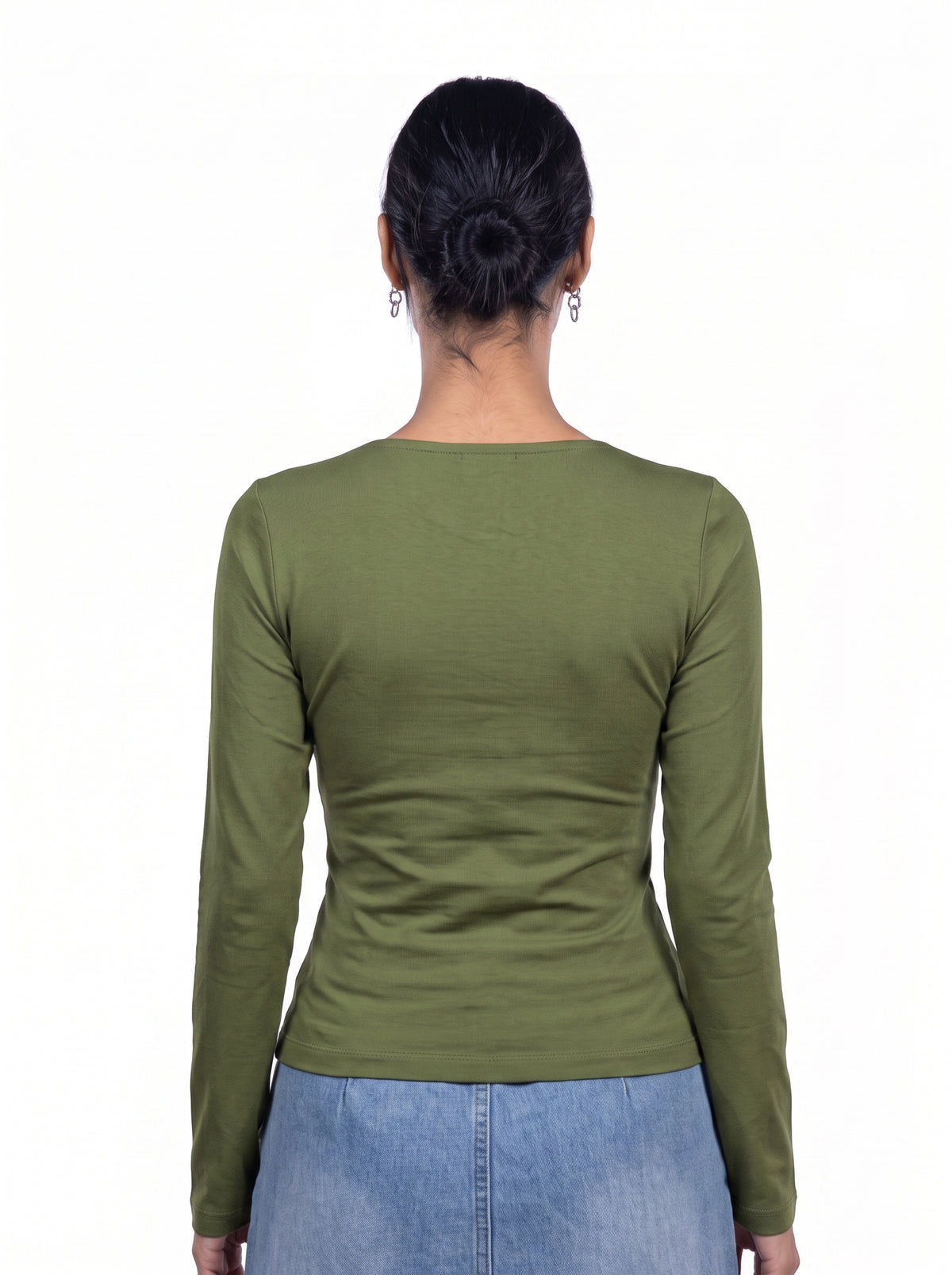 A woman viewed from the back wearing a fitted olive green long-sleeve top and light blue jeans against a plain white background.