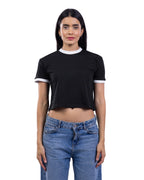 A woman modeling a black short-sleeve ringer crop top with white trim on the crew neck and sleeve cuffs, paired with blue jeans, against a plain white background. [model:2]