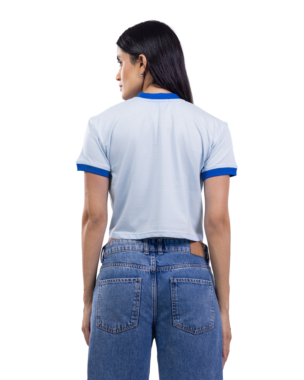 A woman shown from the back wearing a light blue ringer t-shirt with blue trim on the collar and sleeve cuffs, paired with blue jeans, against a plain white background.