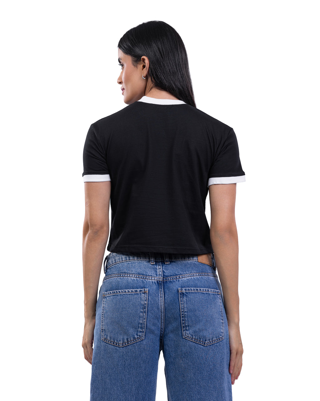 A woman shown from the back wearing a black short-sleeve ringer T-shirt with white trim on the collar and sleeve cuffs, paired with blue jeans, against a plain white background.