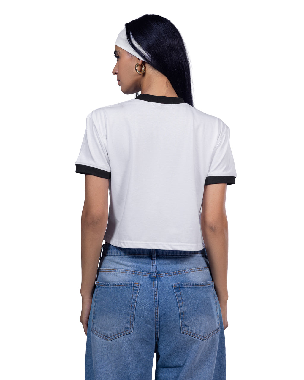 A woman shown from the back wearing a white ringer T-shirt with black trim on the collar and sleeve cuffs, paired with blue jeans, against a plain white background.