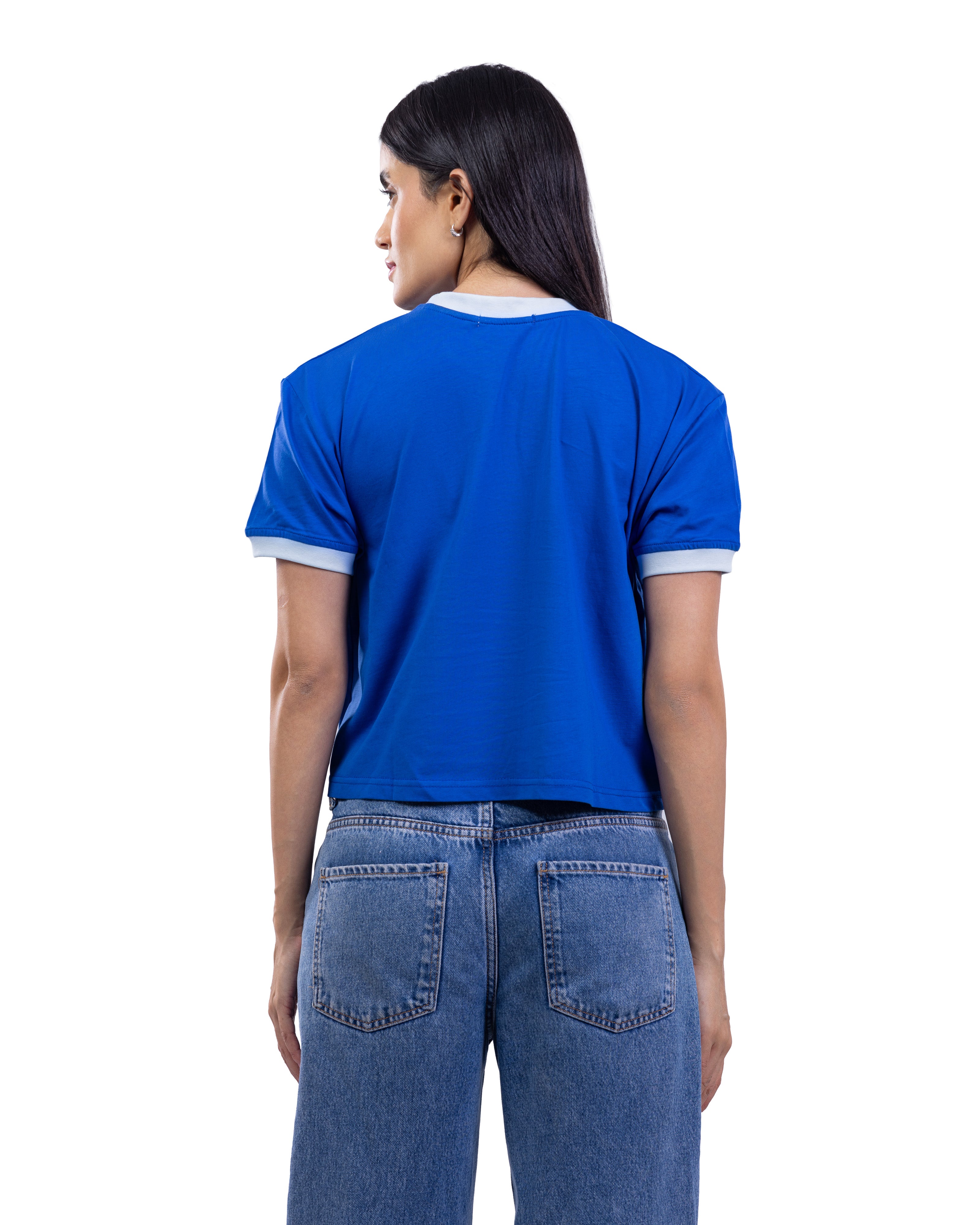 A woman shown from the back wearing a bright blue short-sleeve ringer T-shirt with white trim on the collar and sleeve cuffs, paired with blue jeans, against a plain white background.
