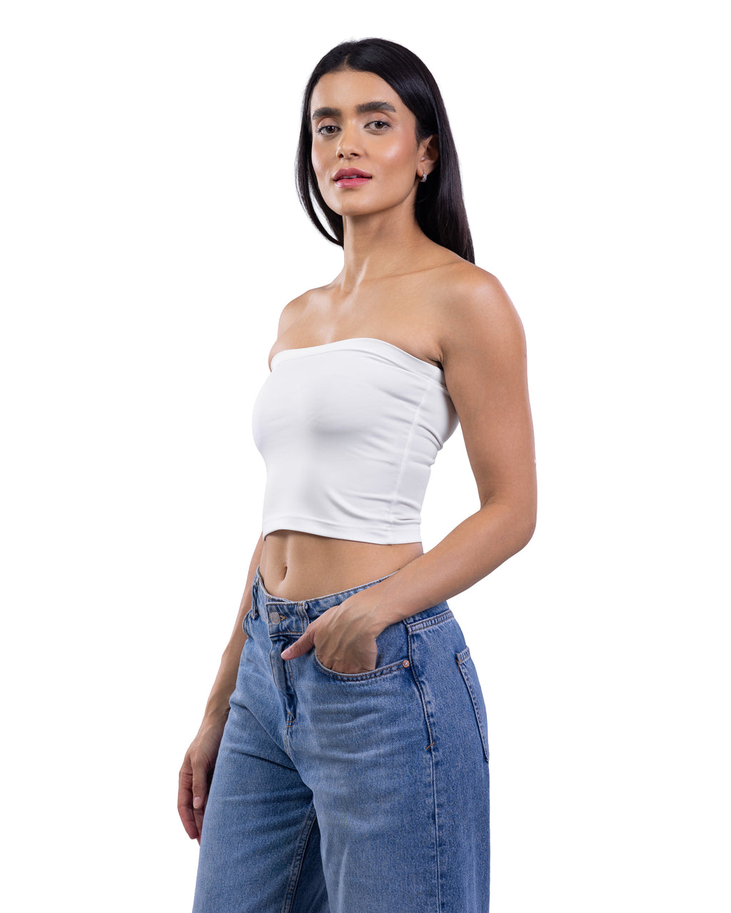 A woman modeling a white strapless bandeau crop top paired with blue jeans, photographed against a solid white background.
