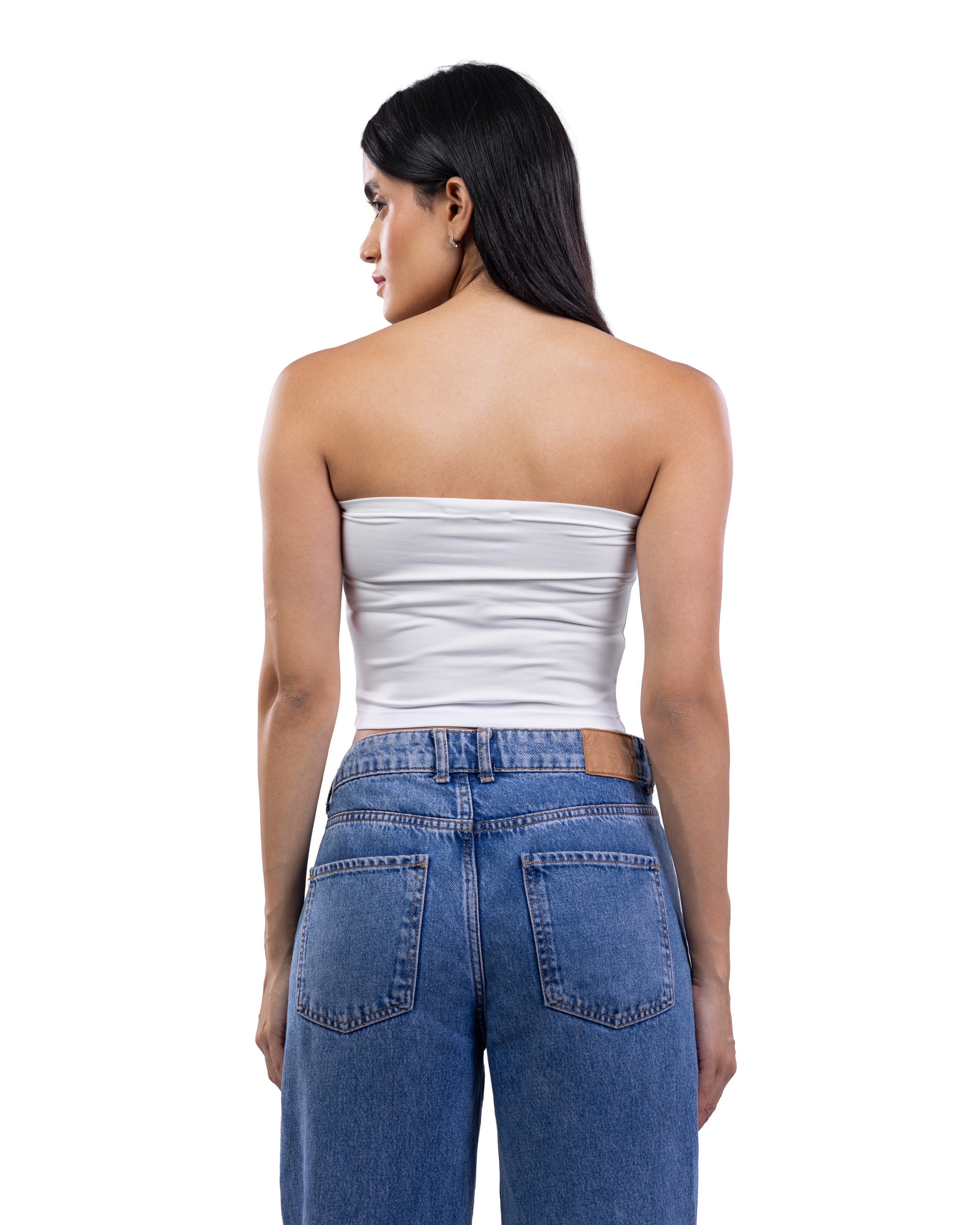 A woman shown from the back wearing a white strapless tube top and blue jeans against a plain white background.
