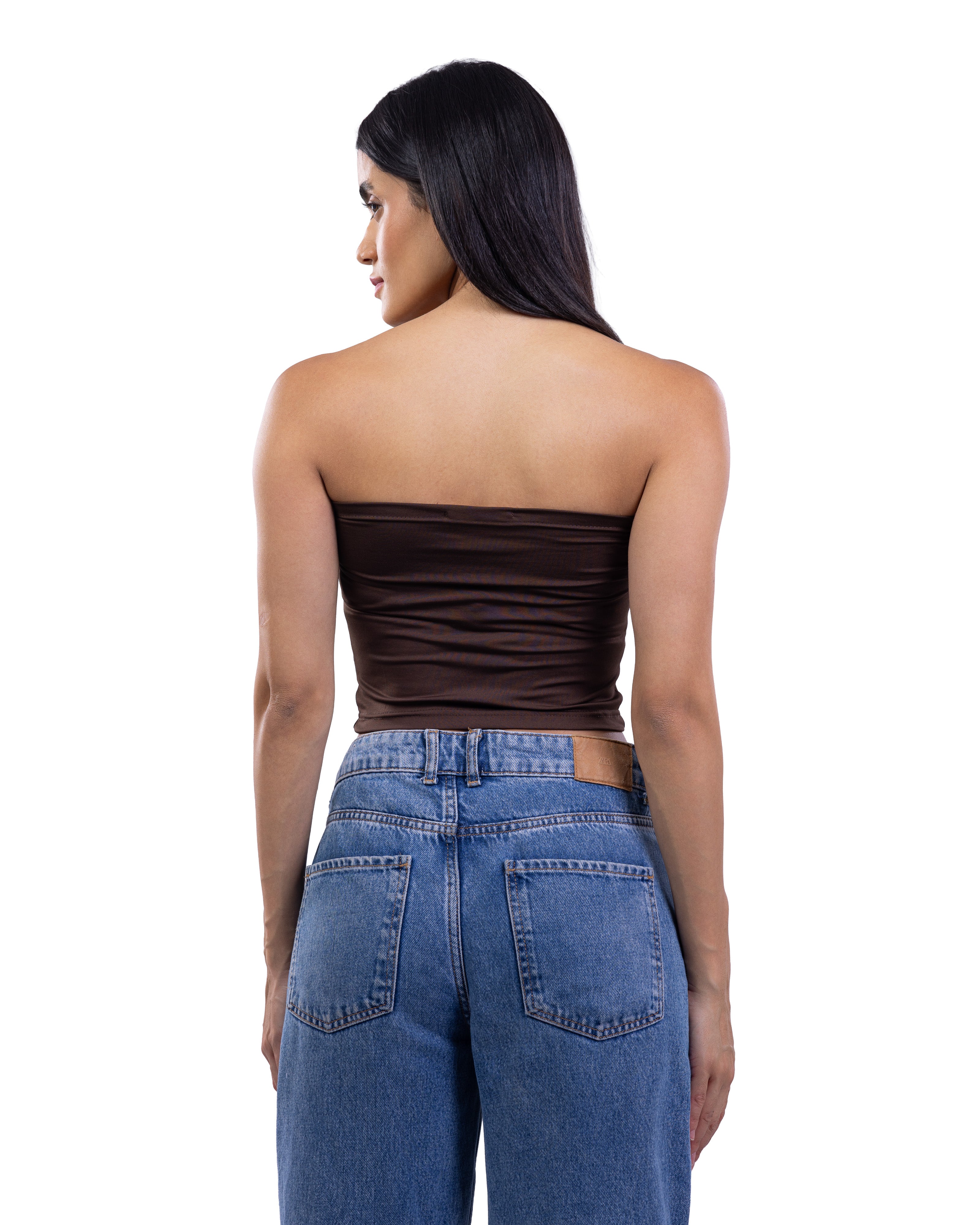 A woman shown from the back wearing a dark brown strapless bandeau tube top and blue jeans against a plain white background.