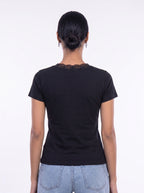 A woman viewed from the back wearing a black short-sleeve t-shirt with a lace-trimmed neckline and light blue jeans, set against a plain white studio background. [model:1]