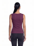 A woman viewed from the back wearing a sleeveless, fitted athletic top in a muted plum-purple color, paired with dark leggings, against a plain white background. [model:1]
