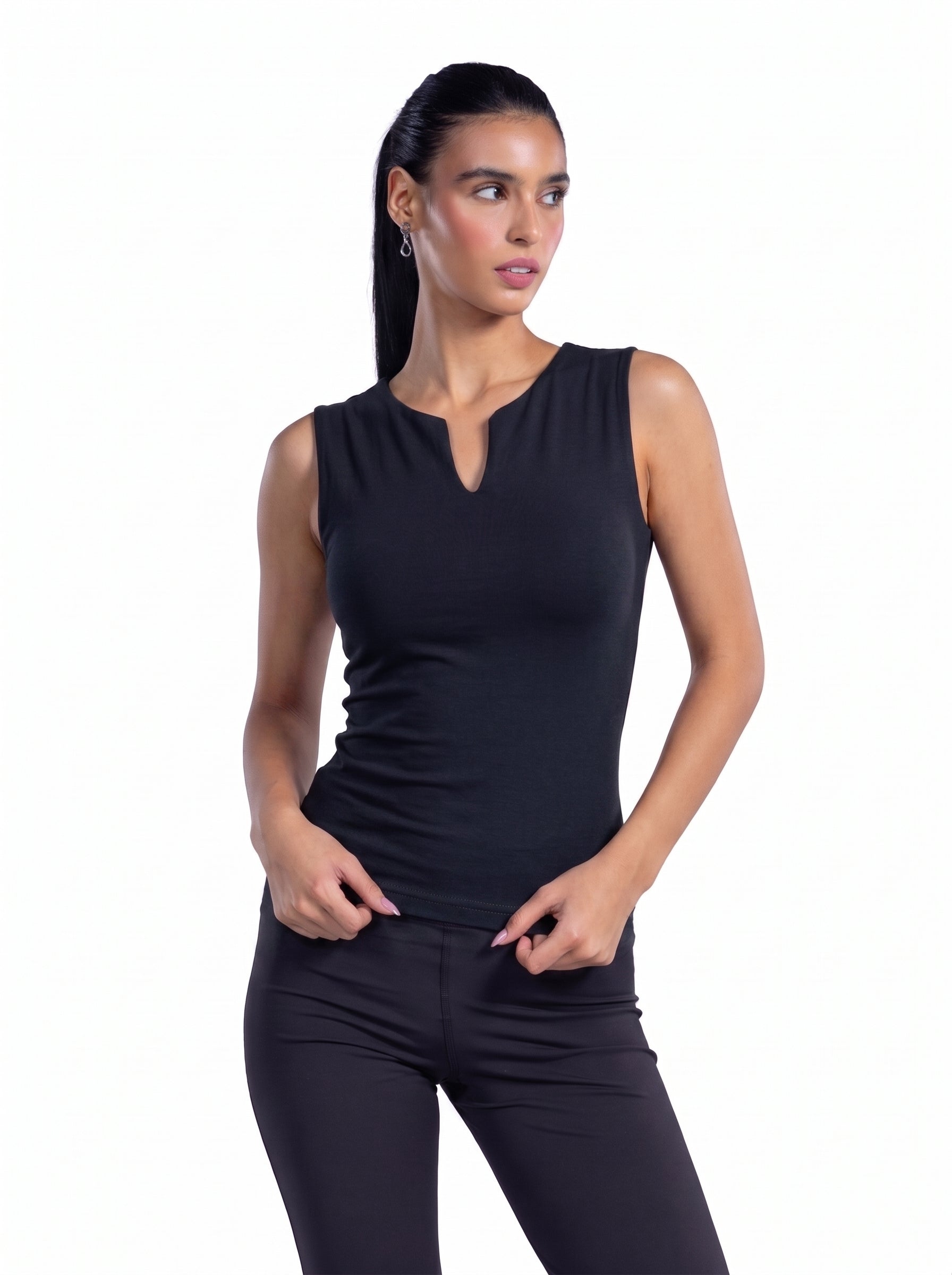 A woman modeling a sleeveless black athletic tank top with a split neckline, paired with black leggings, against a plain white background.