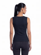 A woman shown from the back wearing a sleeveless black athletic top and black leggings against a plain white background. [model:1]
