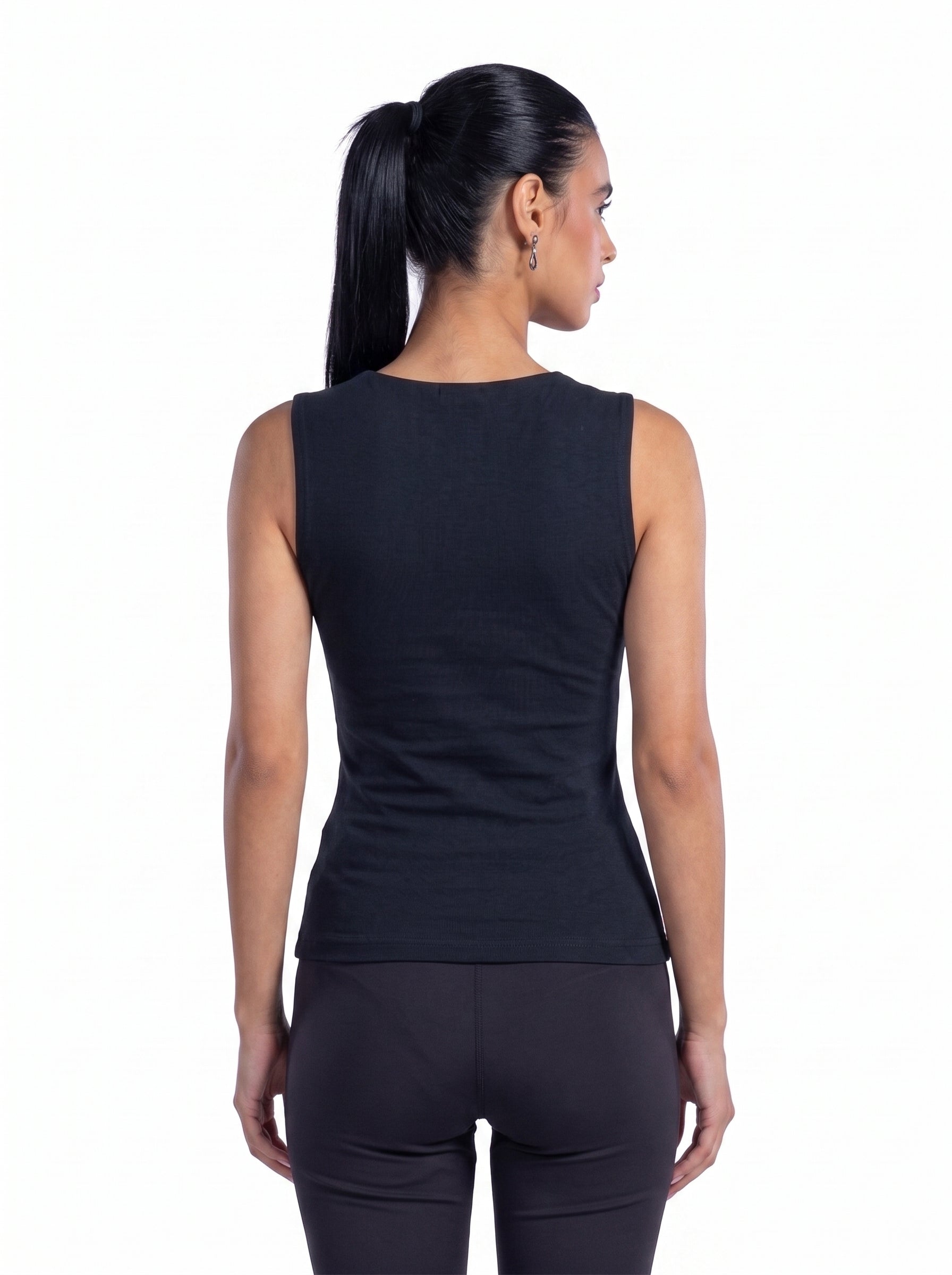 A woman shown from the back wearing a sleeveless black athletic top and black leggings against a plain white background.
