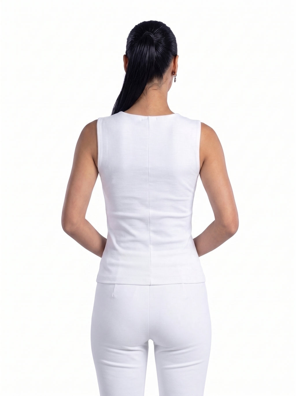 A woman shown from the back wearing a fitted sleeveless white top and white pants against a plain white studio background.