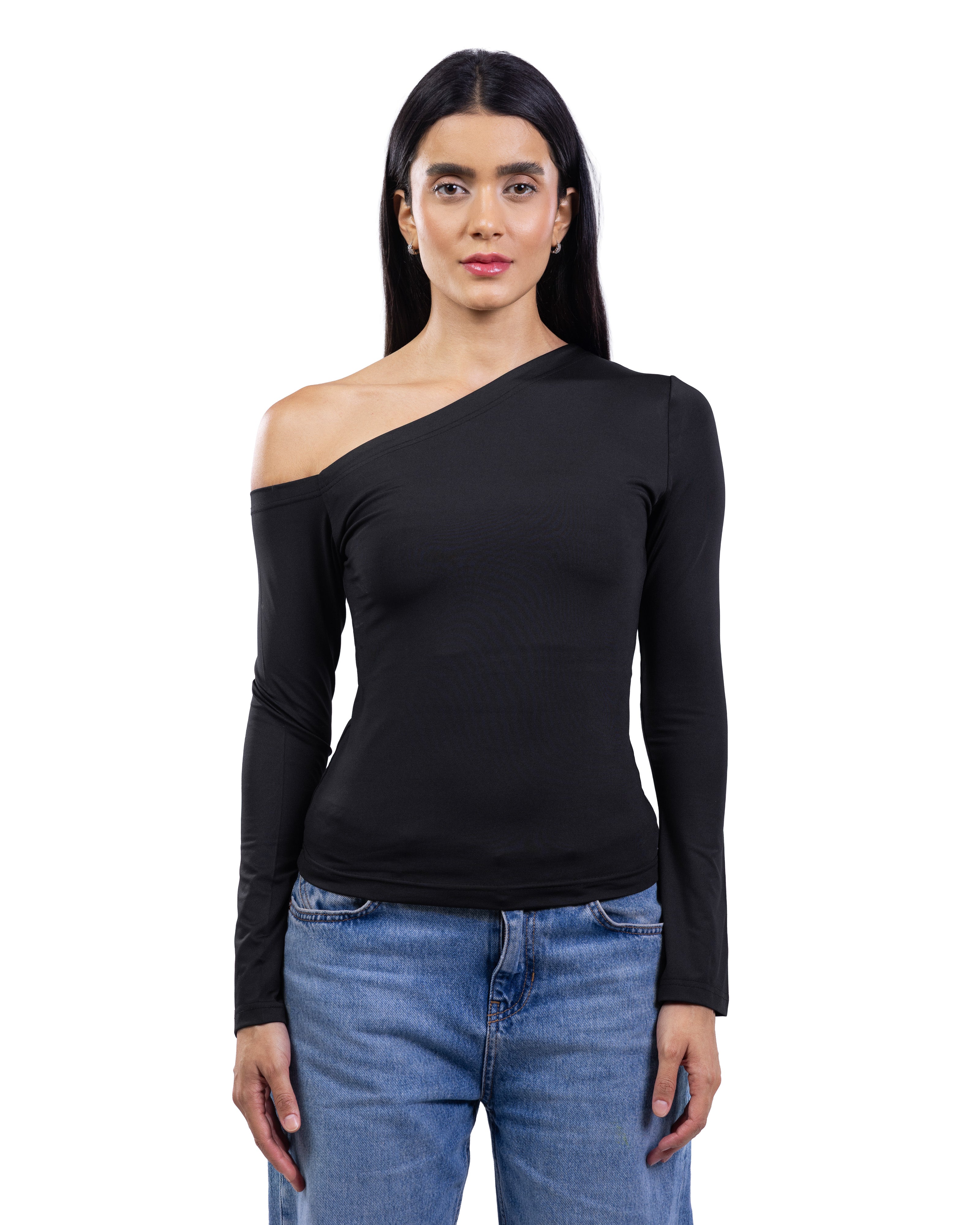 A woman modeling a black long-sleeve asymmetrical one-shoulder top paired with blue jeans, shot against a plain white background.