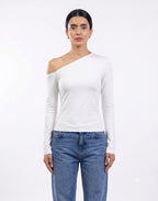 A model wearing a white long-sleeve asymmetrical one-shoulder top and blue jeans, standing against a plain white studio background. [model:2]