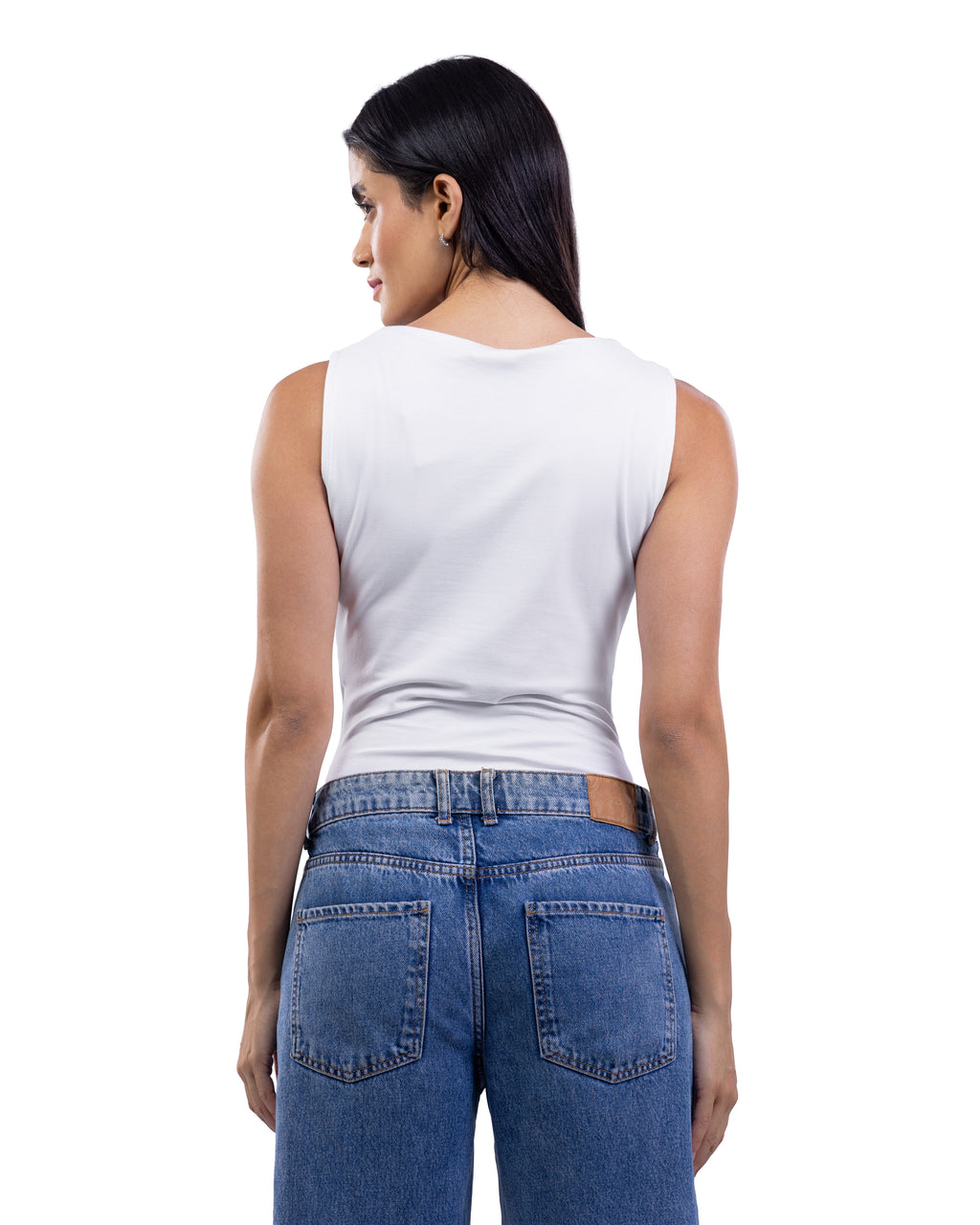 A woman shown from the back wearing a white sleeveless top and blue jeans against a plain white background.