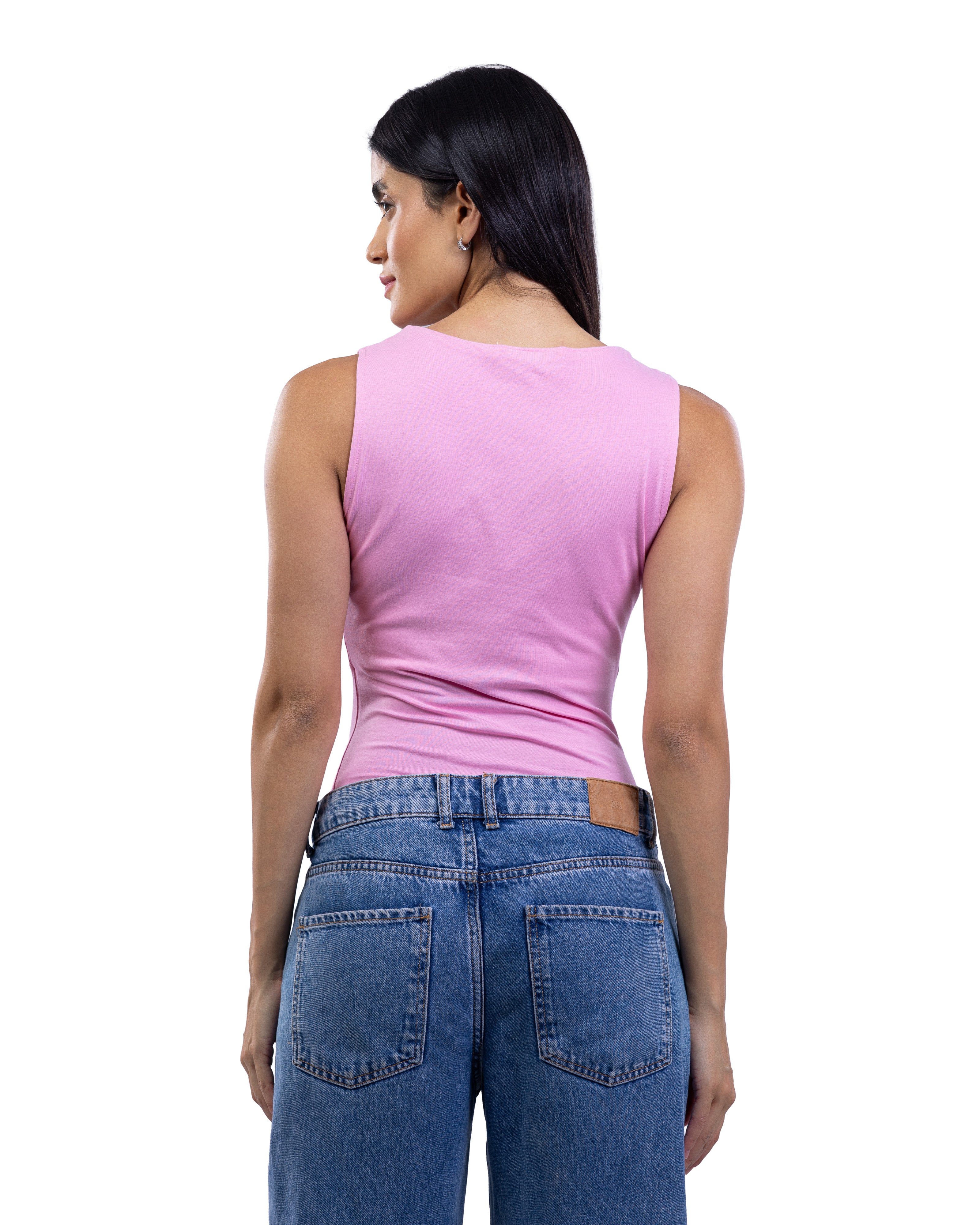 A woman shown from the back wearing a sleeveless pink top and blue jeans against a plain white background.