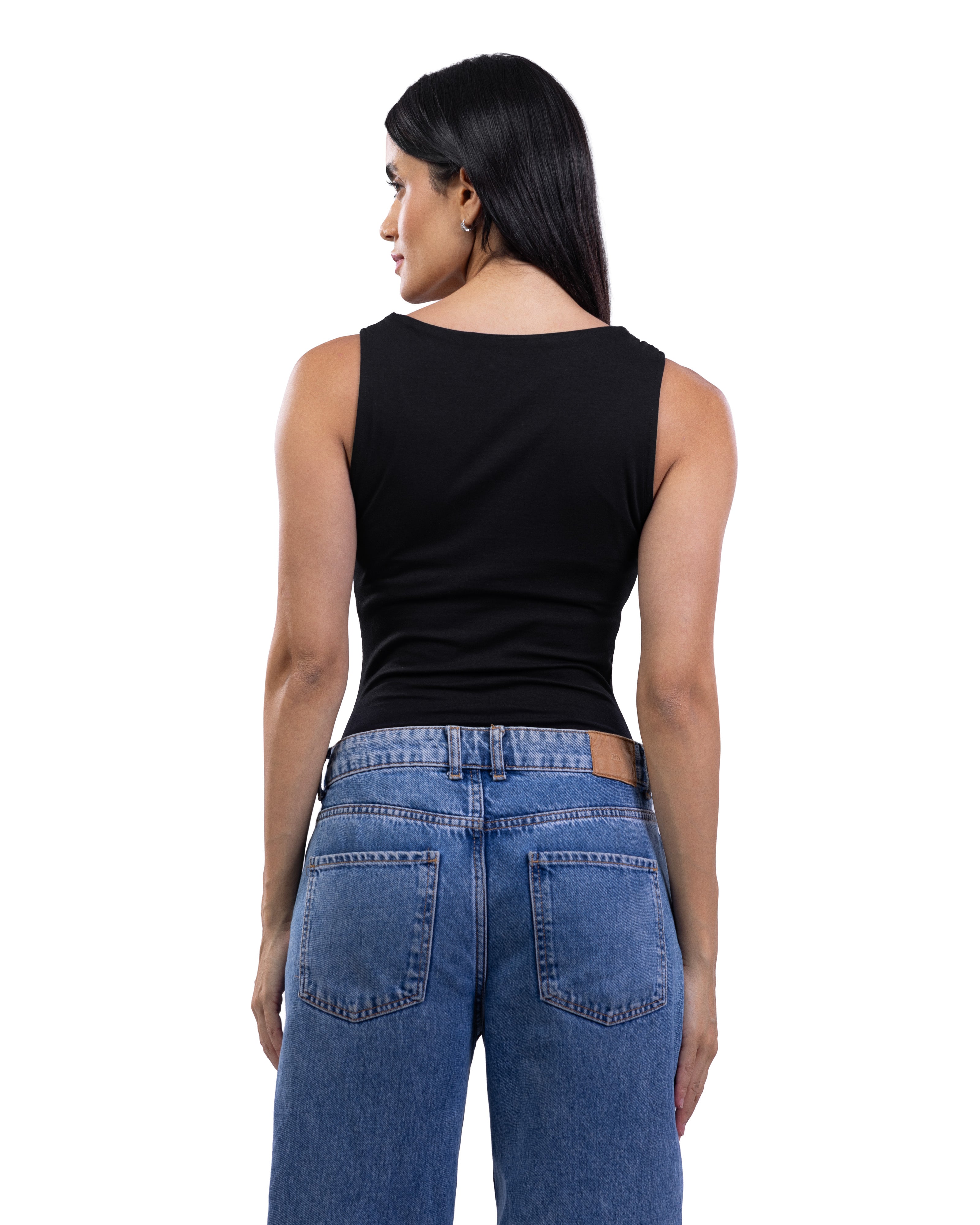 A woman shown from the back wearing a fitted black sleeveless top and blue jeans against a plain white studio background.