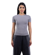 A woman modeling a fitted short-sleeve crewneck top in light gray, paired with dark gray wide-leg pants, against a plain white background. [model:2]