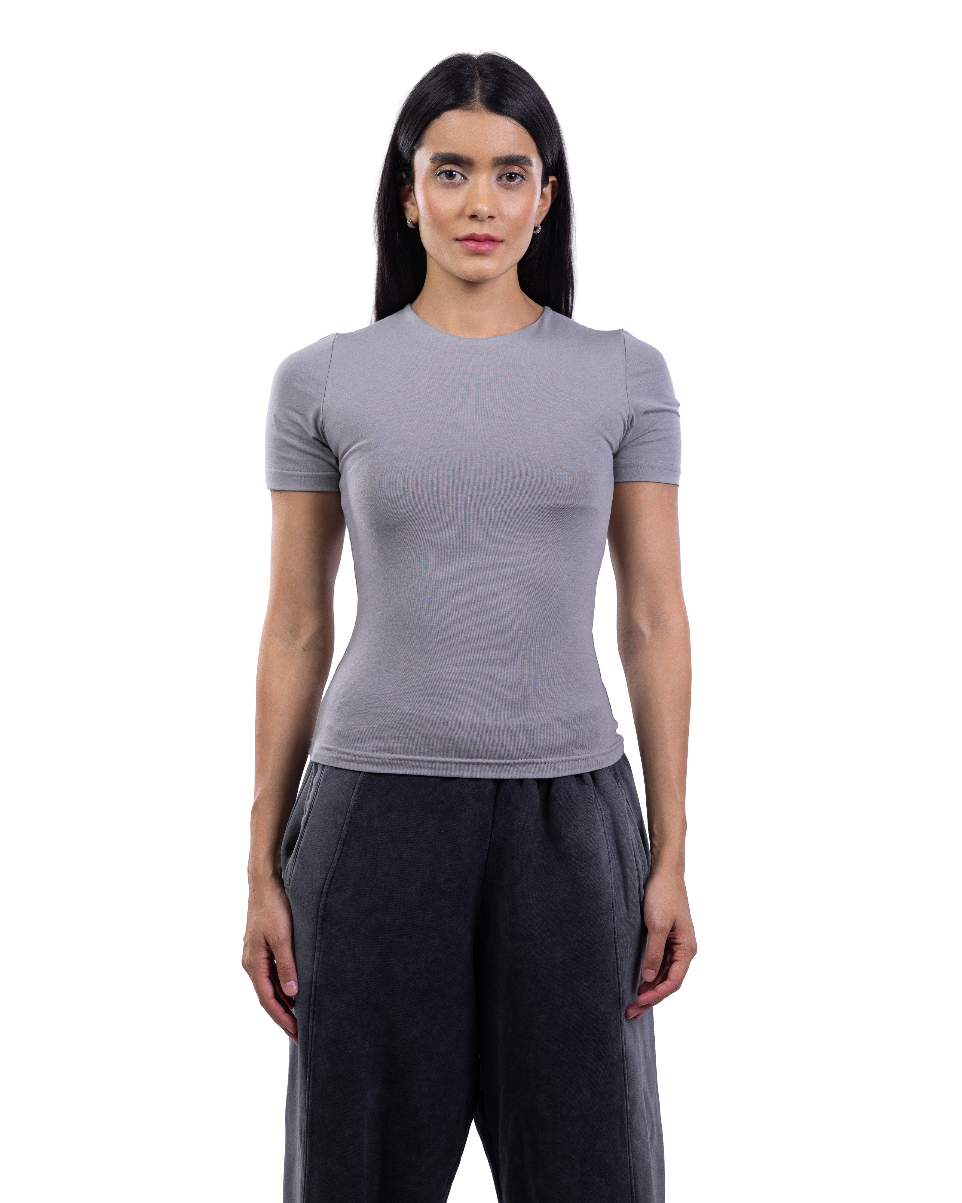A woman modeling a fitted short-sleeve crewneck top in light gray, paired with dark gray wide-leg pants, against a plain white background.