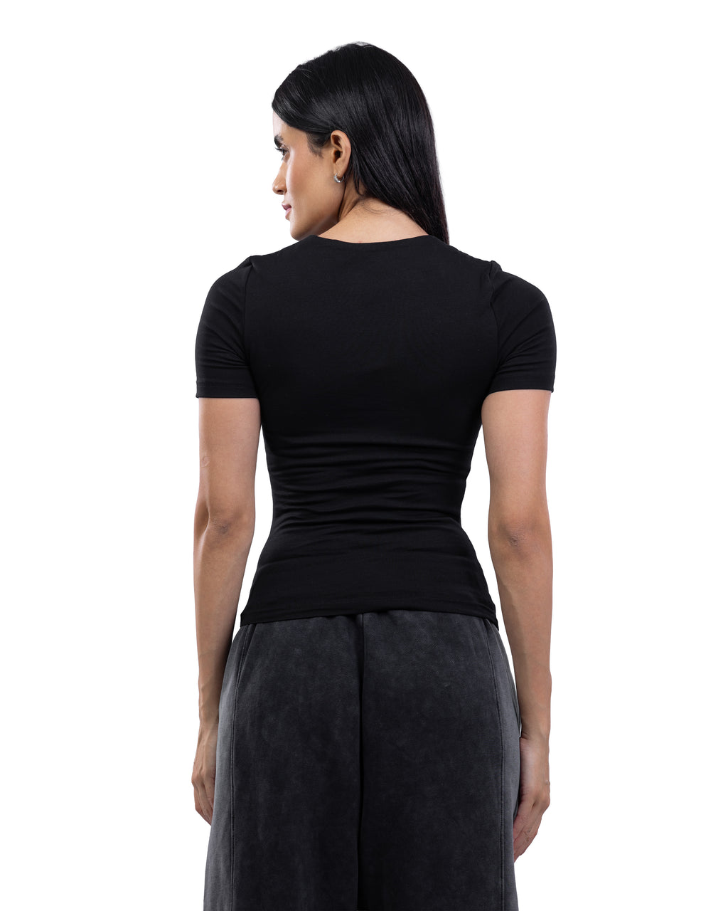 A woman shown from the back wearing a fitted black short-sleeve top and dark gray wide-leg pants against a plain white studio background.