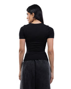 A woman shown from the back wearing a fitted black short-sleeve top and dark gray wide-leg pants against a plain white studio background. [model:2]