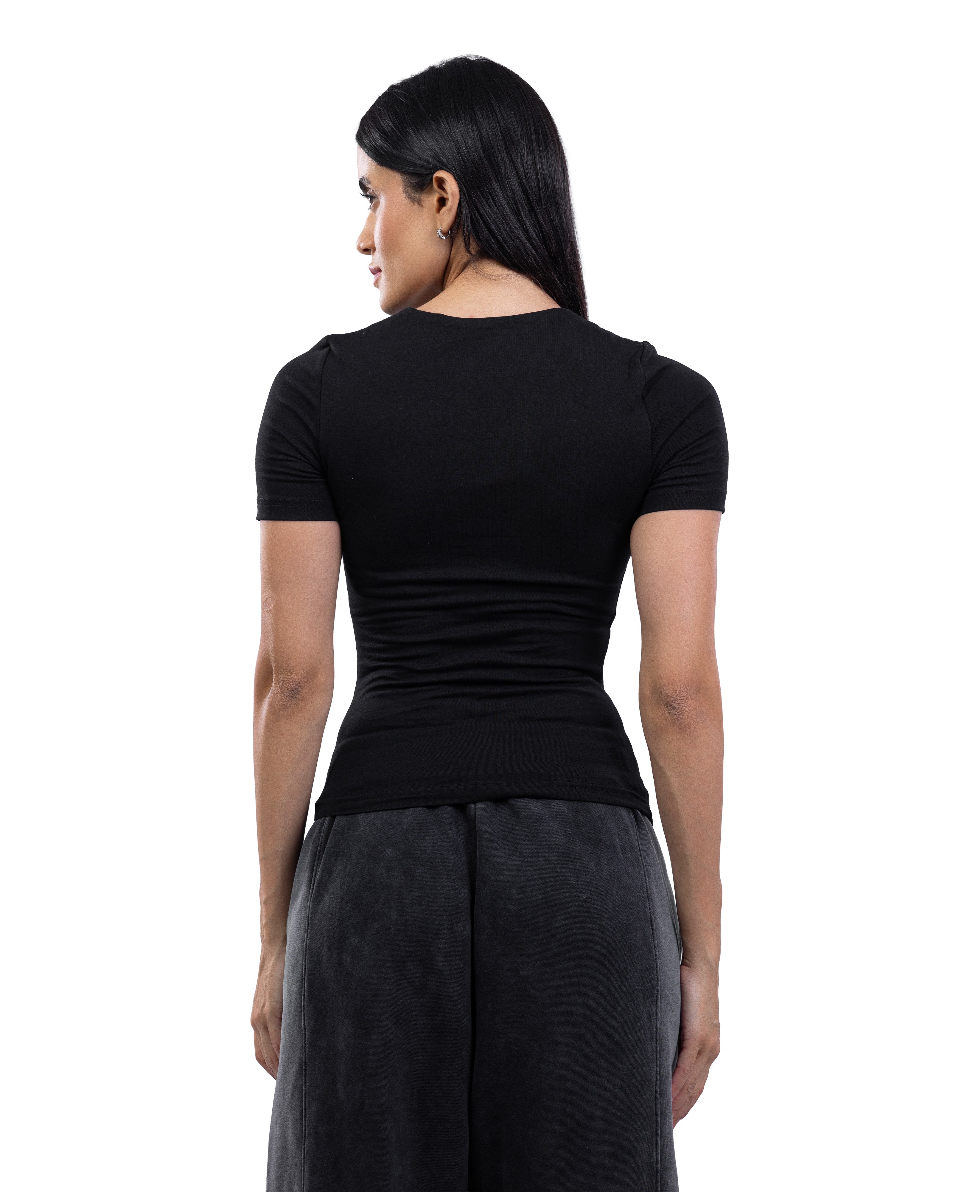 A woman shown from the back wearing a fitted black short-sleeve top and dark gray wide-leg pants against a plain white studio background.