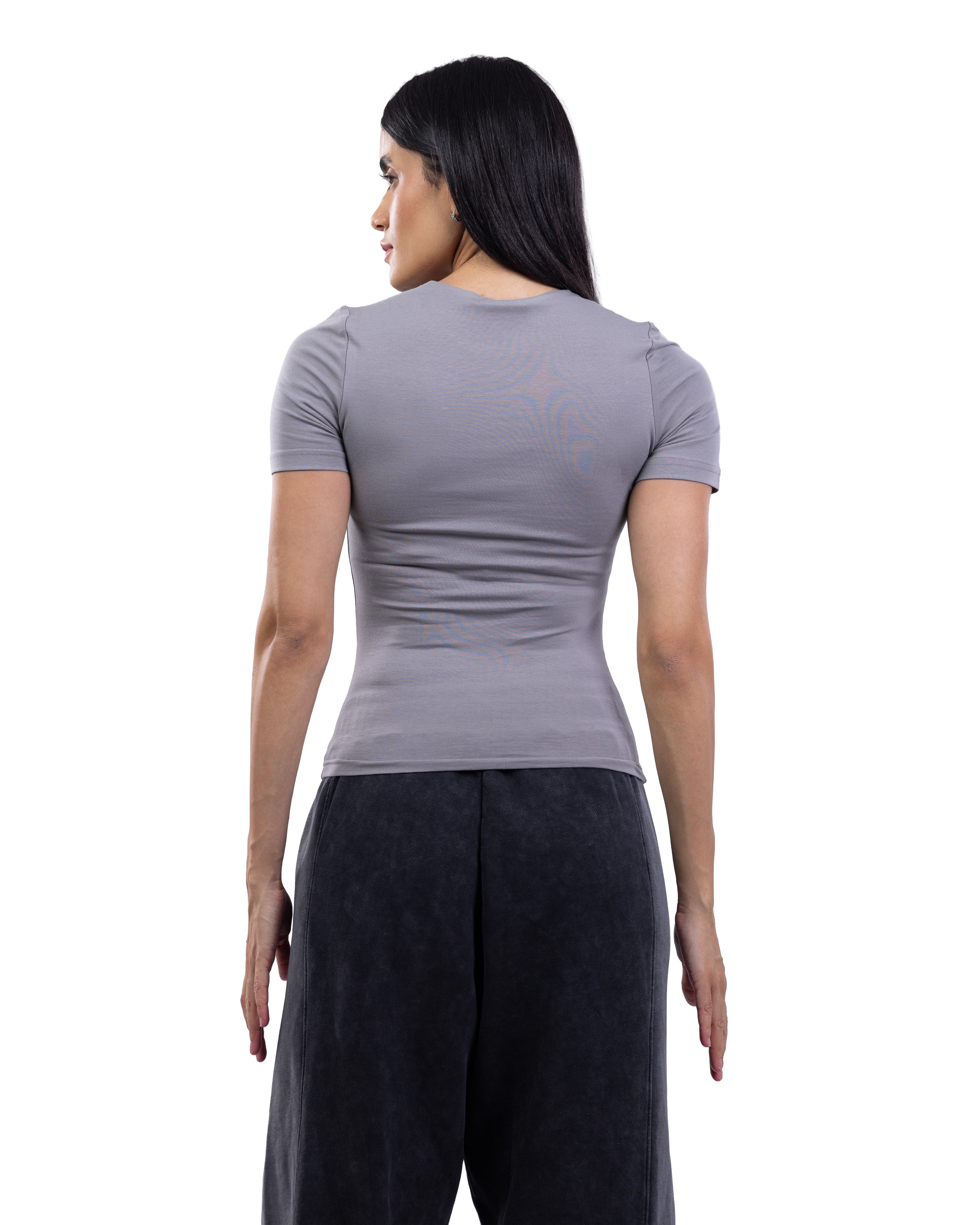 A woman shown from the back wearing a fitted short-sleeve gray t-shirt and dark charcoal pants against a plain white background.