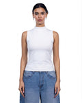 A woman modeling a white sleeveless mock neck top paired with light blue jeans against a plain white background.