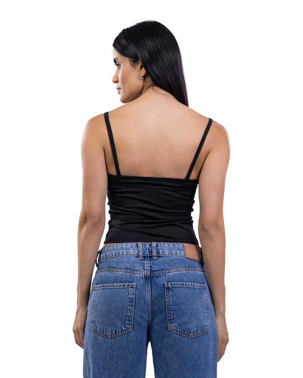 A woman shown from the back wearing a black spaghetti-strap camisole top and blue jeans against a plain white background.