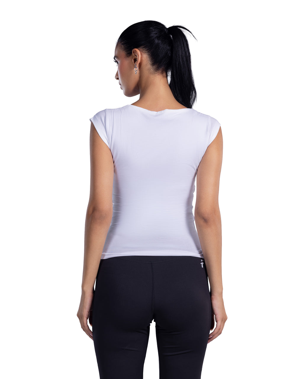A woman shown from the back wearing a fitted sleeveless white top and black leggings against a plain white studio background.