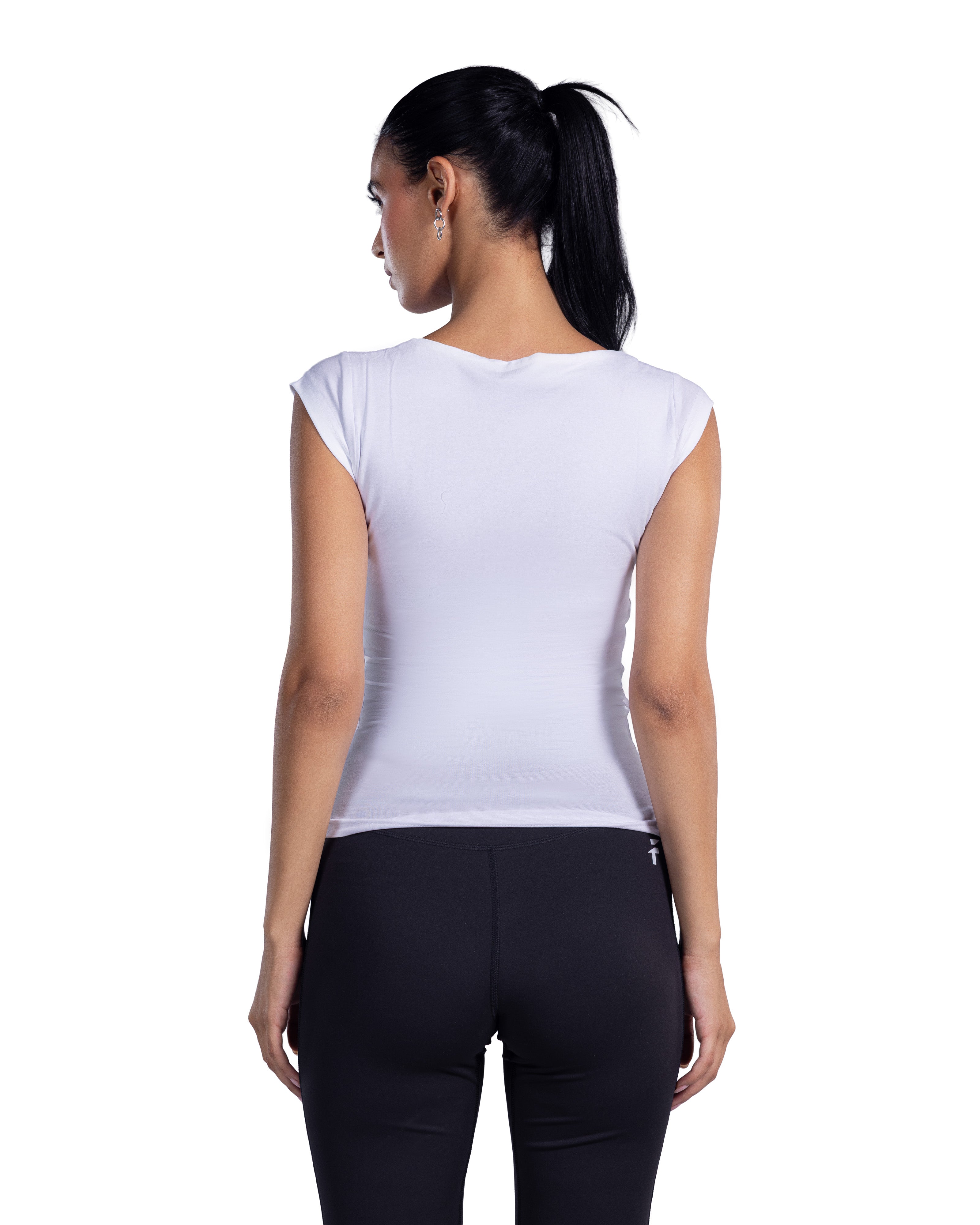 A woman shown from the back wearing a fitted sleeveless white top and black leggings against a plain white studio background.