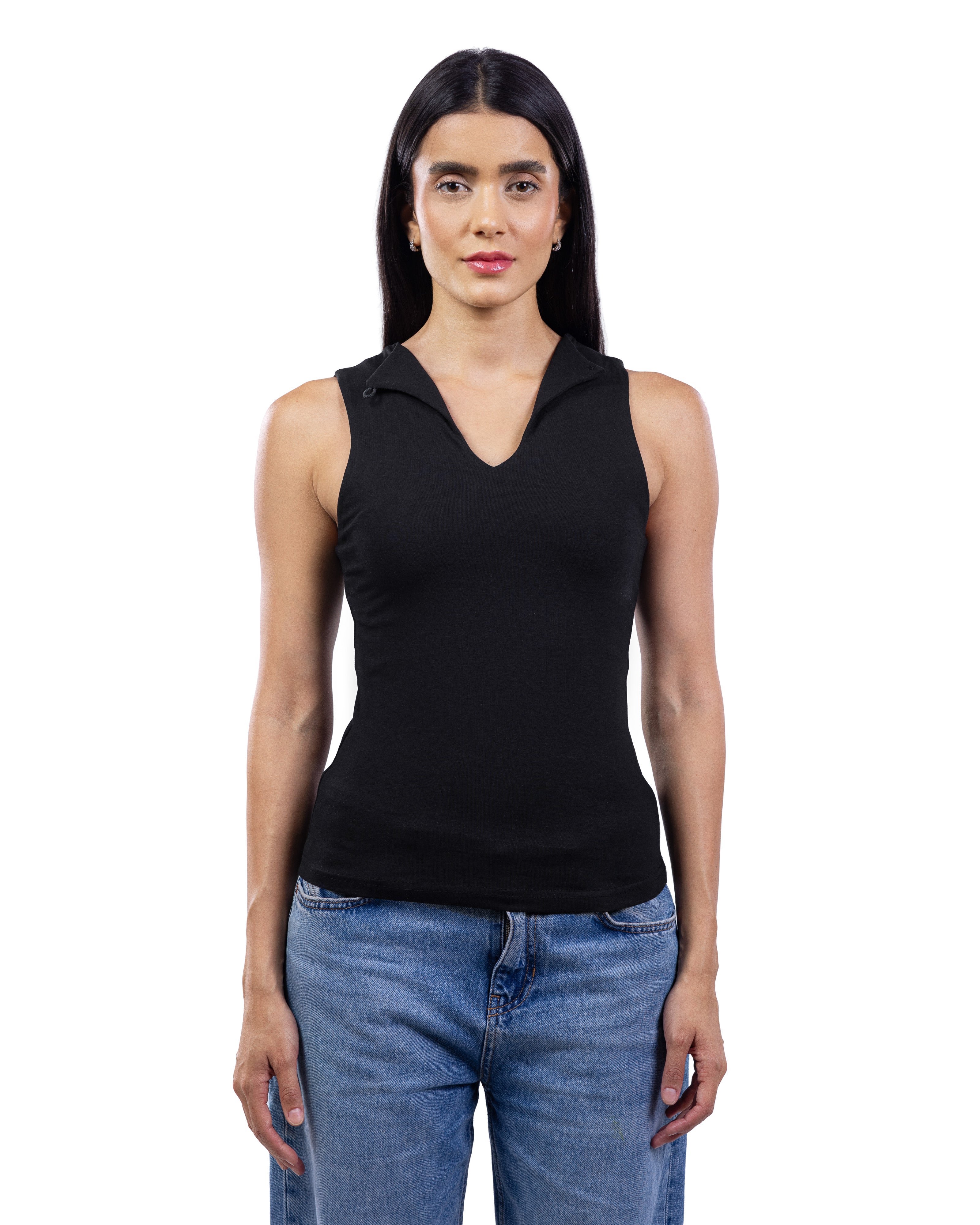 A woman modeling a black sleeveless knit top with a V-neck and a small collar detail, paired with blue jeans, against a plain white background.