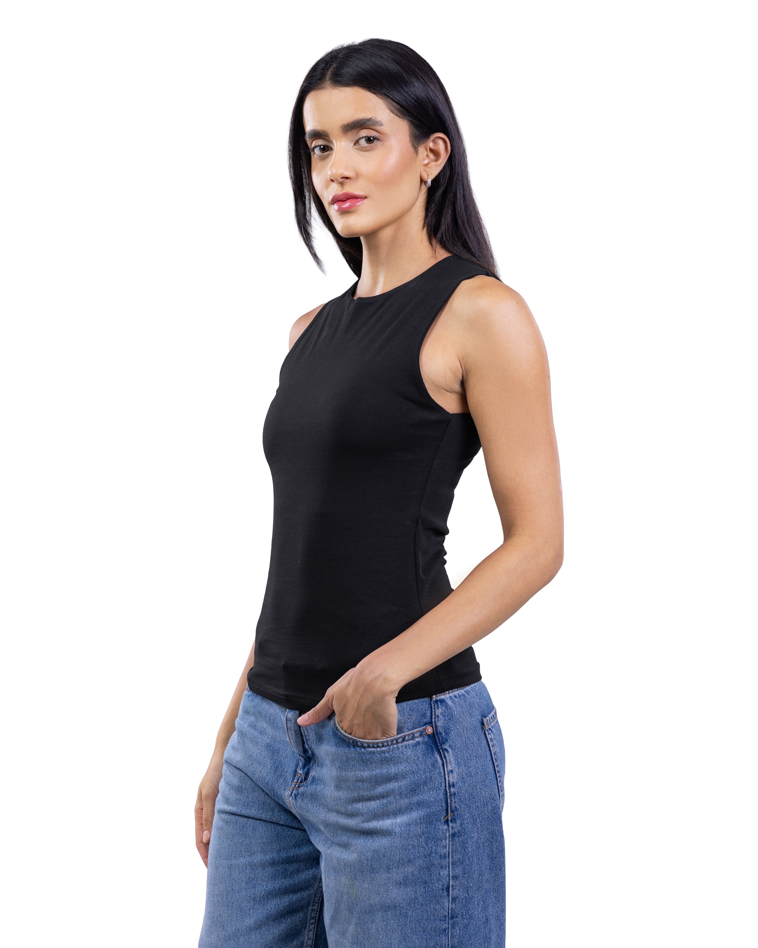 A woman modeling a black sleeveless mock-neck tank top paired with blue jeans, photographed against a solid white background.