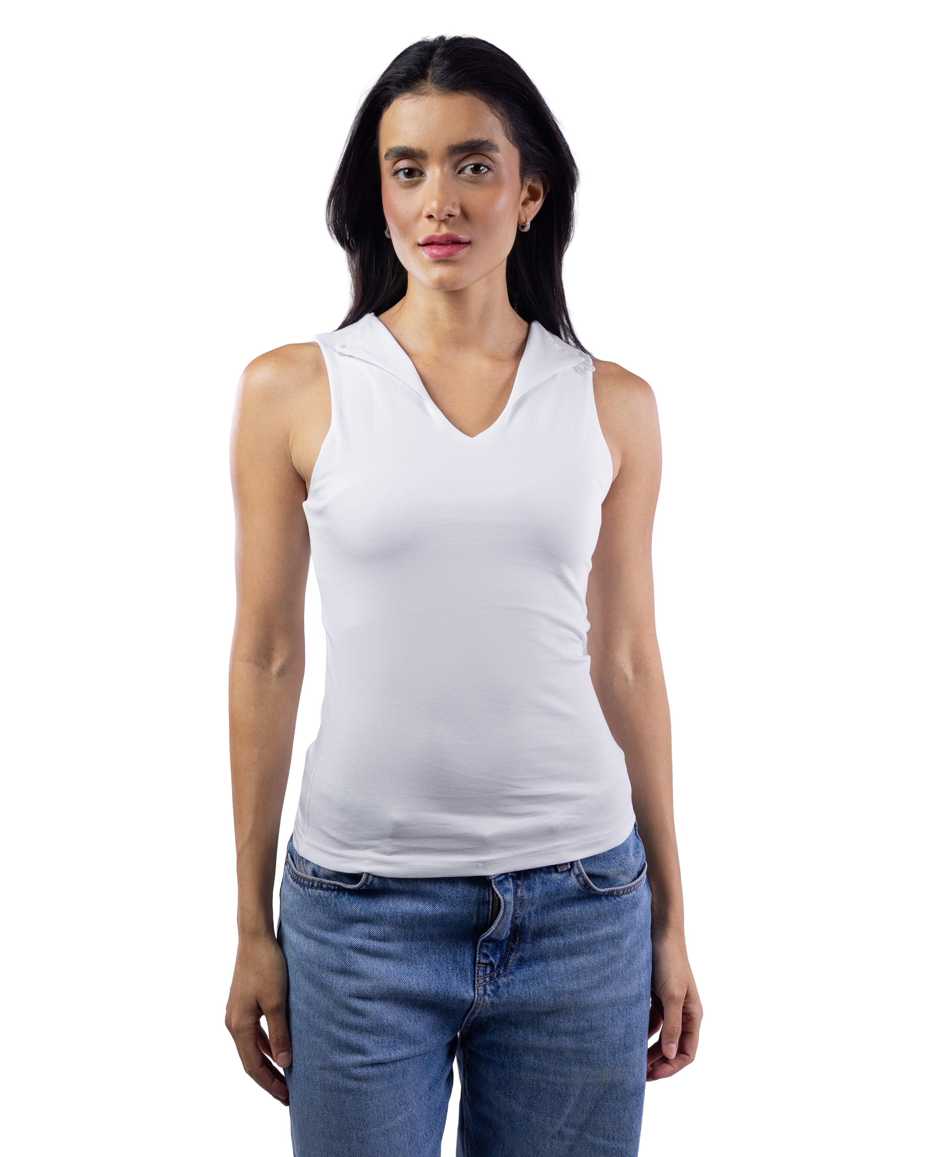 A woman modeling a white sleeveless V-neck tank top paired with blue jeans, photographed against a solid white background.