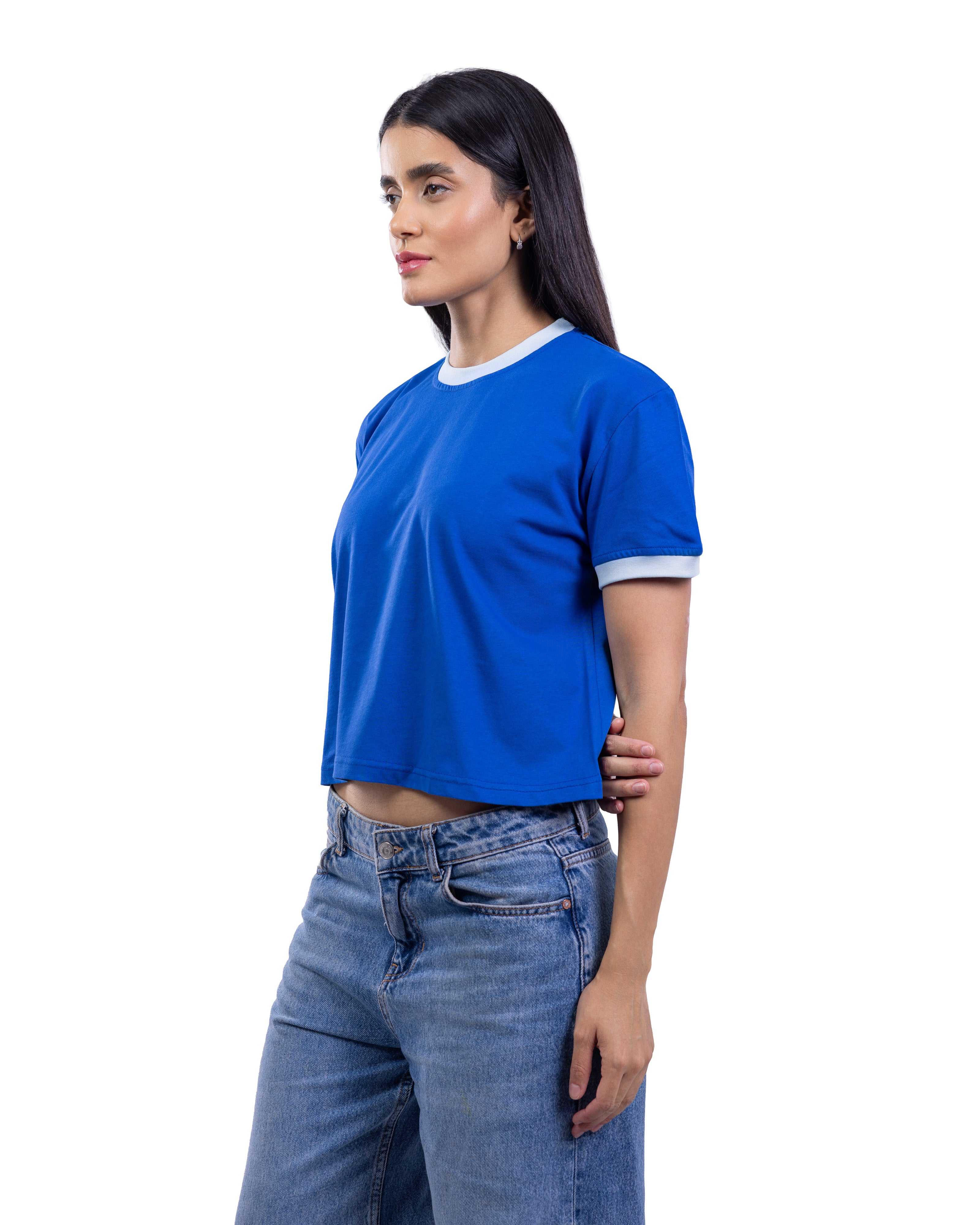 A woman wearing a bright blue short-sleeve ringer t-shirt with white ribbed trim at the collar and sleeve cuffs, paired with blue jeans, shown against a plain white background.